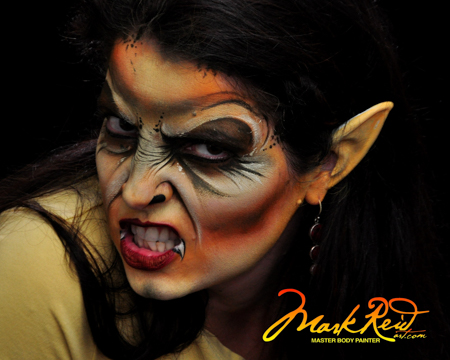 black haired woman with an impressive vampire themed face painting